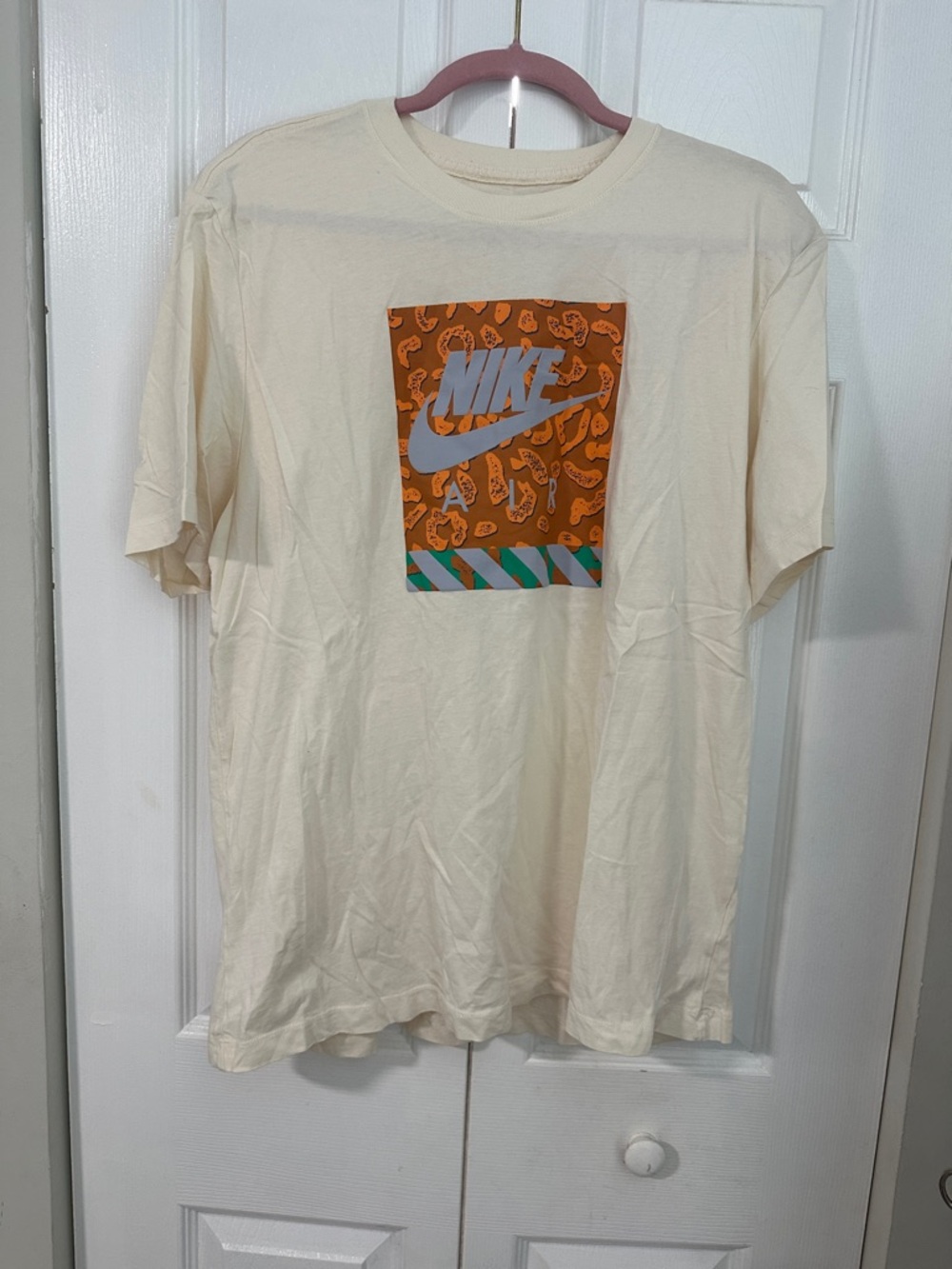 Nike Men’s Cream Short‑Sleeve Tee with Orange Graphic